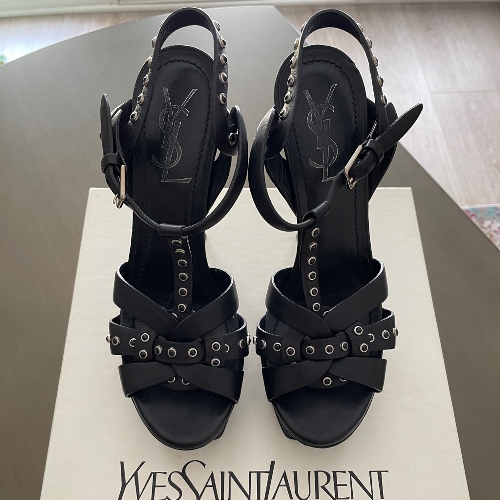 Yves Saint Laurent Tribute sandals in black leather with studs.